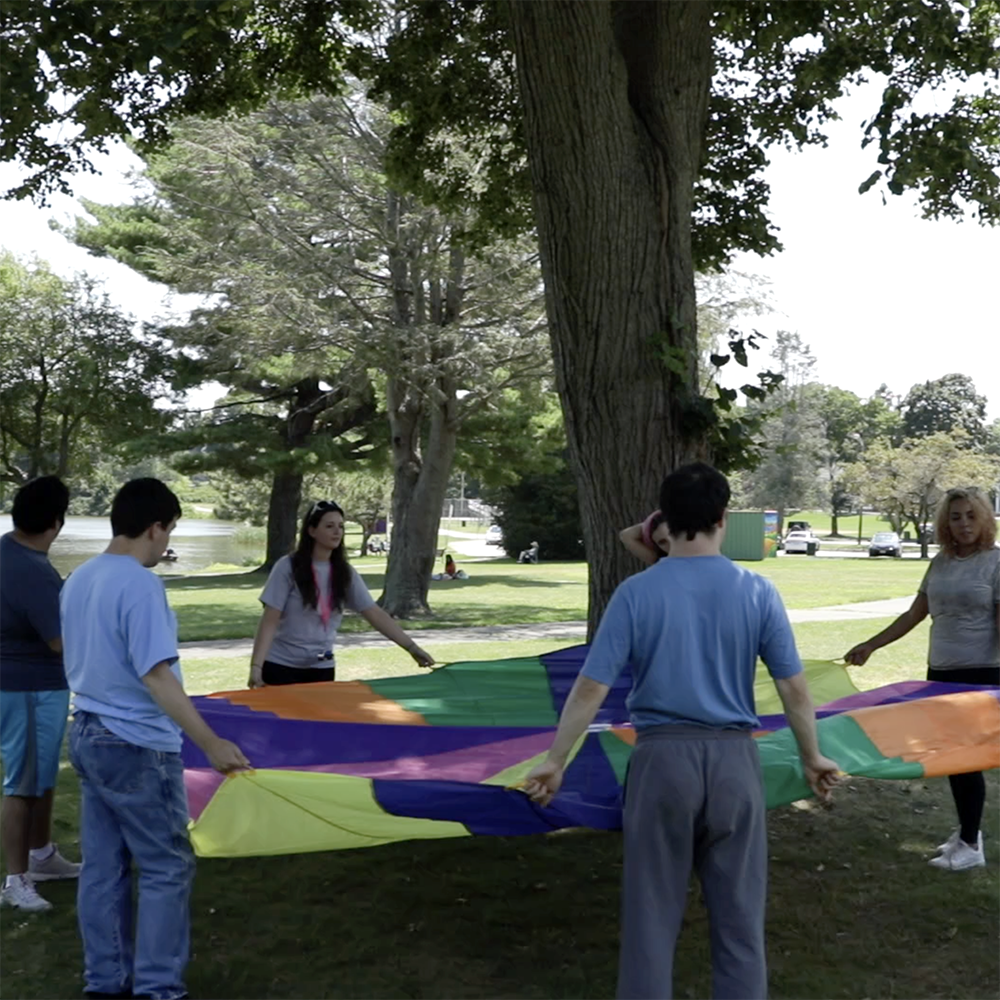 Group playing with a parachute